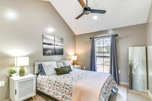 a bedroom with a bed and a ceiling fan at 1 Mi to Davis Wade Stadium Walkable Paradise! in Starkville