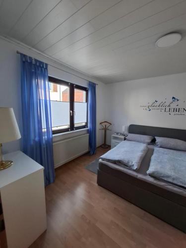 a bedroom with a bed and a large window at Schöne 3 Zi. Ferienwohnung vor den Toren Frankfurt in Dreieich