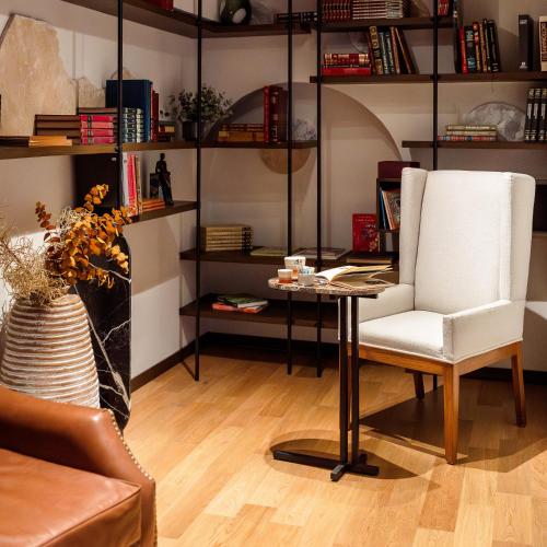 a living room with a table and a chair at Casa 63 Hotel Boutique & Spa in San Miguel de Allende