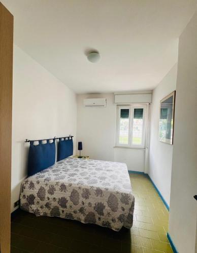 a bedroom with a bed in a white room at Villaggio Turistico Valle Scinni in Peschici