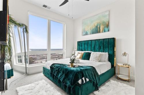a bedroom with a green bed with a green headboard at NEW! Royal Penthouse King Bed Amazing Views! in Atlanta
