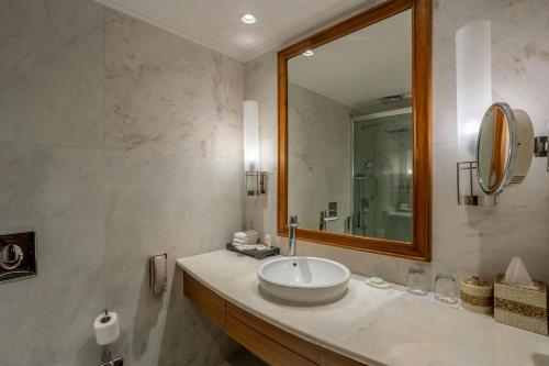 a bathroom with a sink and a mirror at ITC Mughal, A Luxury Collection Resort & Spa, Agra in Agra