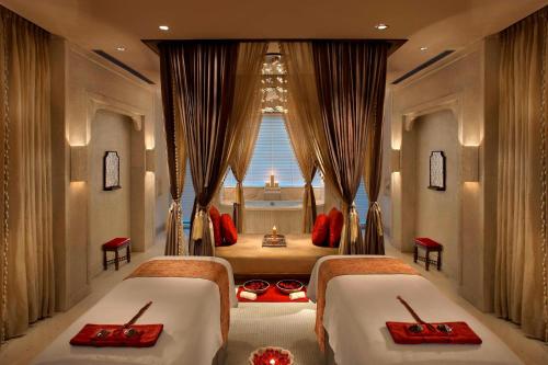 a bedroom with two beds and a window at ITC Mughal, A Luxury Collection Resort & Spa, Agra in Agra