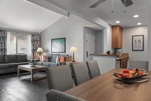 a kitchen and living room with a table and chairs at Club Wyndham Dolphin's Cove in Anaheim