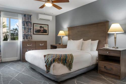 a hotel room with a large bed and a window at Club Wyndham Dolphin's Cove in Anaheim