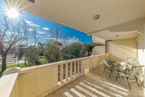 a balcony with a table and chairs on it at Apartment Sofija Petrovac in Petrovac na Moru