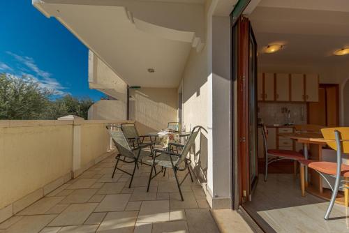 a patio with chairs and a table on a balcony at Apartment Sofija Petrovac in Petrovac na Moru