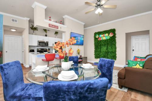 a living room with blue chairs and a glass table at Nintendo Super Mario Arcade - 2BR-NRG-Med-Center-Galleria in Houston