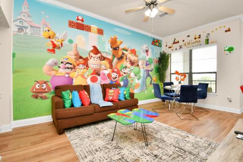 a living room with a cartoon characters mural on the wall at Nintendo Super Mario Arcade - 2BR-NRG-Med-Center-Galleria in Houston