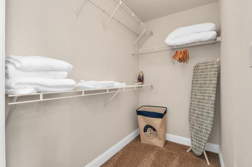 a closet with white towels and a bag at Nintendo Super Mario Arcade - 2BR-NRG-Med-Center-Galleria in Houston