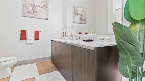 a bathroom with a sink and a toilet in it at NEW! ChateauOasis PenthouseViews KingBed FreePark in Atlanta