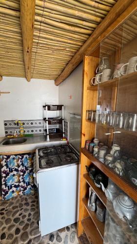 a kitchen with a stove and a white refrigerator at Fisherman House in Wassane