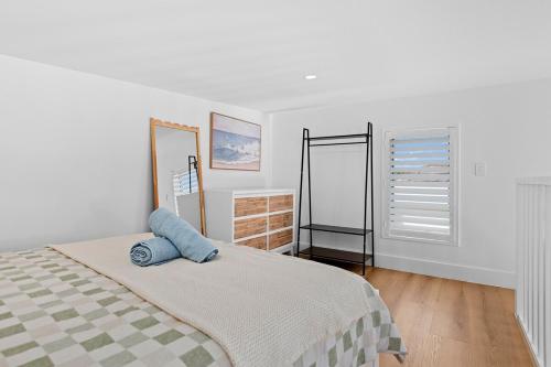 En eller flere senge i et værelse på The Cot at The Entrance