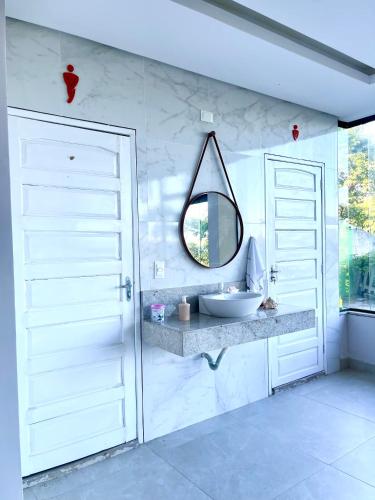 a bathroom with a sink and a mirror at Recanto sol nascente in Rio Formoso