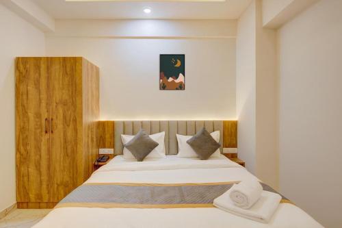 a bedroom with a large bed in a room at Hotel Tree Suites Next Airport Inn in Bengaluru