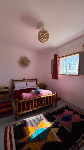 a bedroom with a bed and a rug on the floor at Fisherman House in Wassane