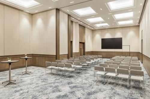 a conference room with chairs and a screen at JW Marriott Auckland in Auckland