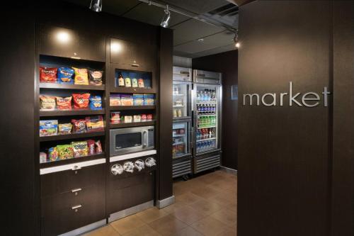 a grocery store aisle with a market refrigerator at Courtyard by Marriott Albuquerque Airport in Albuquerque