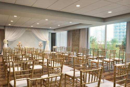 a room with rows of chairs in a room with windows at Twelve Downtown, Autograph Collection in Atlanta