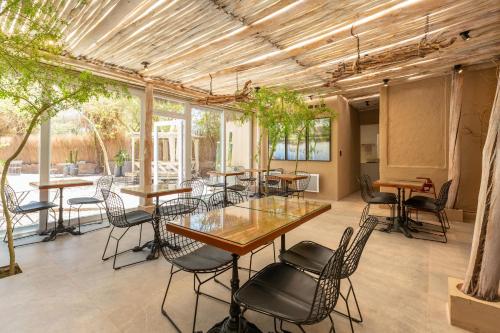 a group of tables and chairs in a room at Casa Solcor Boutique Bed & Breakfast in San Pedro de Atacama