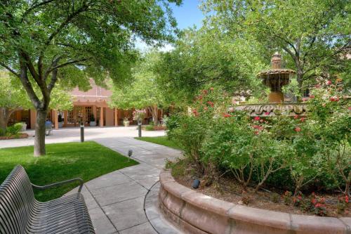 a park with two benches and a fountain at Courtyard by Marriott Albuquerque in Albuquerque