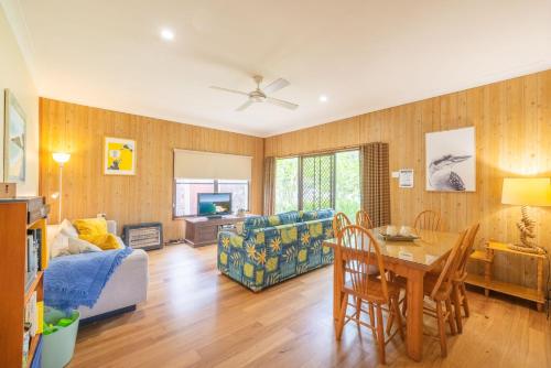 a living room with a couch and a table at The Beach Shack 28 Shoal Bay Road fantastic original beach house that allows pets in Shoal Bay