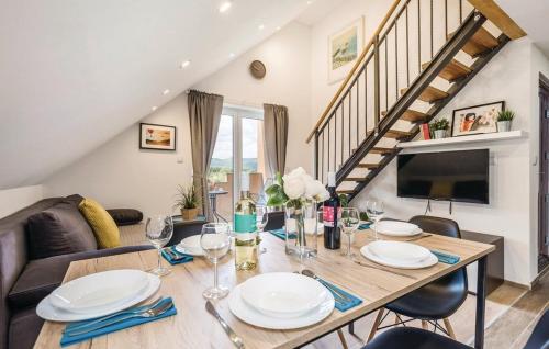 a dining room with a table with plates and wine glasses at Apartments for families with children Jasenak, Karlovac - 17932 in Jasenak