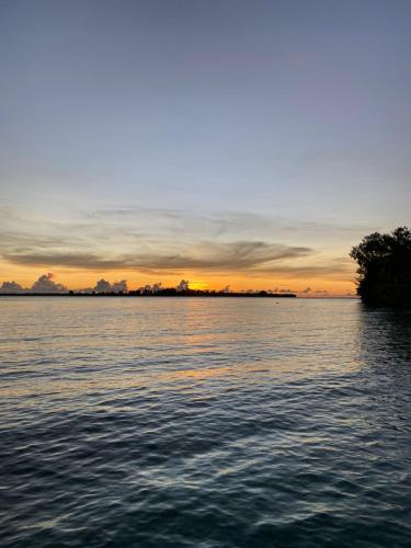 a sunset over a large body of water at Fam Homestay in Fam