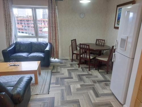 a living room with a couch and a table at Apartment Middle of city center in Belfast