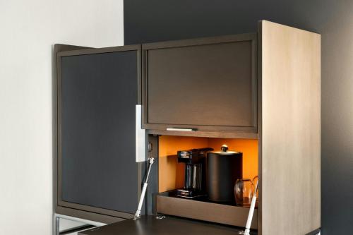 a cupboard with a coffee maker in it at Courtyard by Marriott Gainesville GA in Gainesville