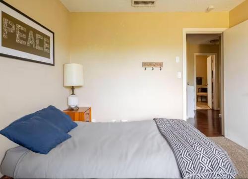 a bedroom with a bed with blue pillows on it at Mid-Century Hideaway - privat Pool & King Bed in Yucca Valley