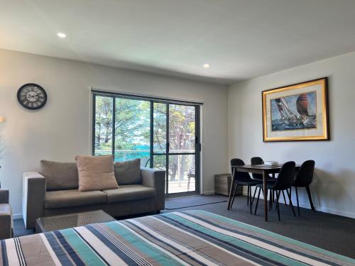 a living room with a couch and a table at Phillip Island Holiday Apartments in Cowes