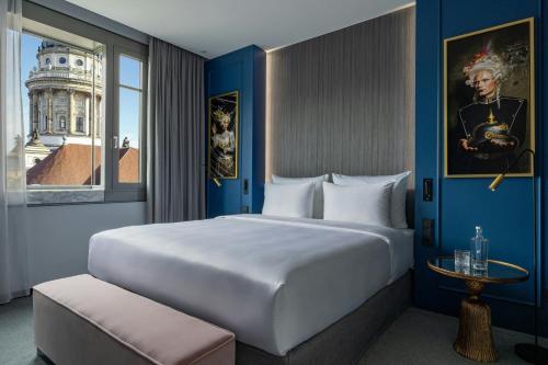a hotel room with a large bed and a window at Hotel Luc, Autograph Collection in Berlin