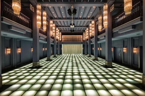 an empty corridor in a building with lights at Hotel Luc, Autograph Collection in Berlin
