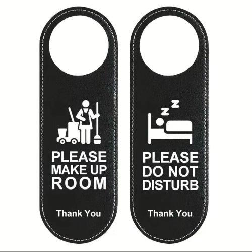 a couple of black doors with a do not disturb sign at Rosenheim Tokyo Shinjuku in Tokyo