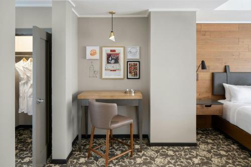 a bedroom with a desk and a bed and a table at Epicurean Atlanta, Autograph Collection in Atlanta