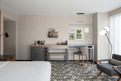a room with a desk and a chair and a bed at Epicurean Atlanta, Autograph Collection in Atlanta