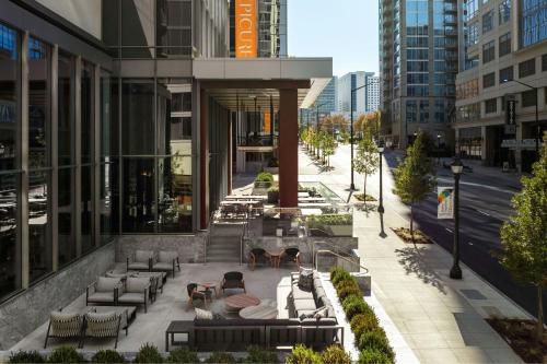 an outdoor patio with couches and tables on a building at Epicurean Atlanta, Autograph Collection in Atlanta