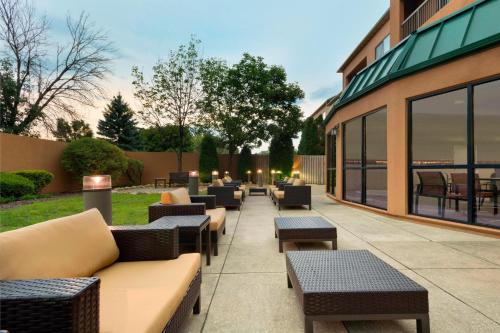 a patio with couches and tables outside of a building at Courtyard Akron Fairlawn in Montrose