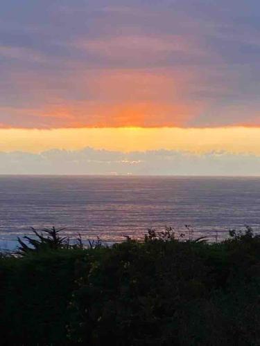 a view of the ocean at sunset at Condominio Fundo Zapallar in Cachagua