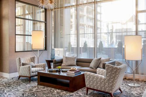 a living room with a couch and chairs and a table at AC Hotel Asheville Downtown in Asheville