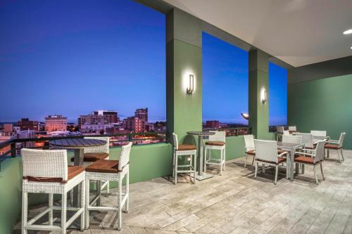 a restaurant with tables and chairs on a balcony at AC Hotel Asheville Downtown in Asheville