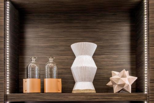 a wooden shelf with two glass vases and a star at AC Hotel Asheville Downtown in Asheville