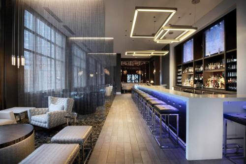 a bar with couches and chairs in a restaurant at AC Hotel Asheville Downtown in Asheville