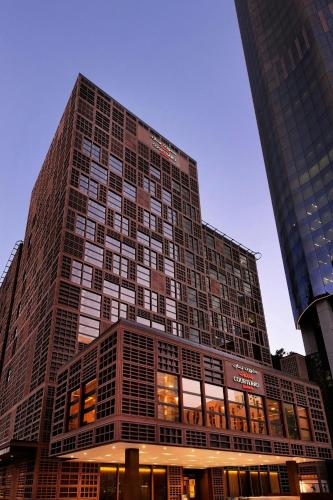 a tall building with many windows in a city at Courtyard by Marriott World Trade Center, Abu Dhabi in Abu Dhabi