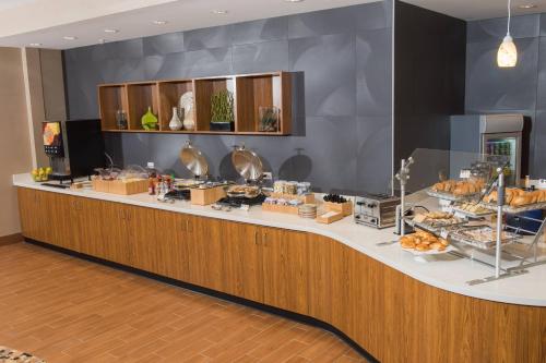 a buffet line with a lot of food on it at SpringHill Suites by Marriott Buffalo Airport in Williamsville