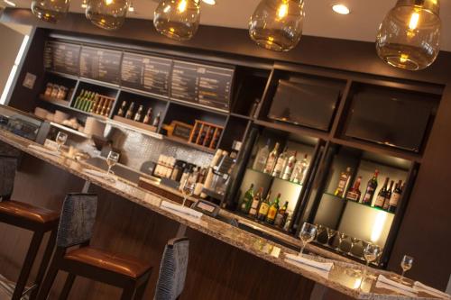 a bar with a lot of bottles of alcohol at Courtyard Aberdeen at Ripken Stadium in Aberdeen