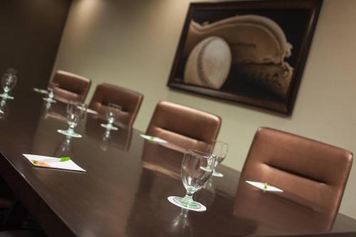 a table with chairs and wine glasses on it at Courtyard Aberdeen at Ripken Stadium in Aberdeen