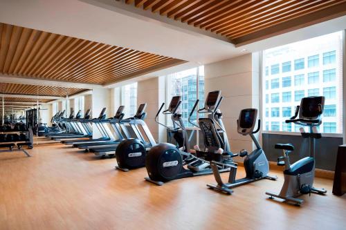 a gym with rows of exercise bikes and treadmills at Courtyard by Marriott Bengaluru Outer Ring Road in Bengaluru
