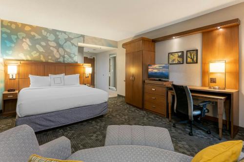 a hotel room with a bed and a desk at Courtyard by Marriott Asheville Airport in Arden